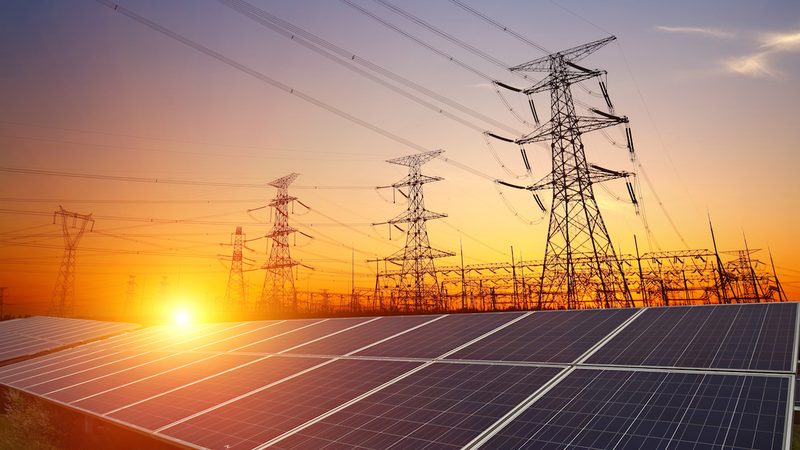 Solar generation integrated with power transmission infrastructure at sunset